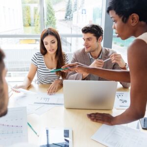 Multiethnic group of young business people preparing for presentation together in office
