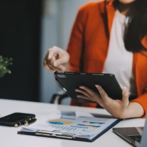Secretary concept, Female secretary sitting on her desk and working with happiness in office.